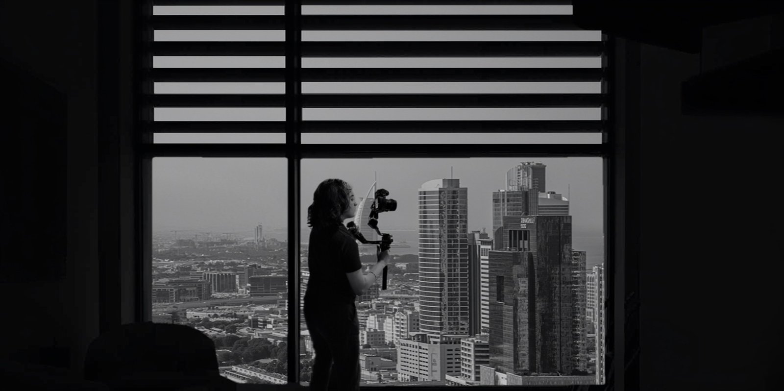 Rida Haider filming against the Dubai skyline
